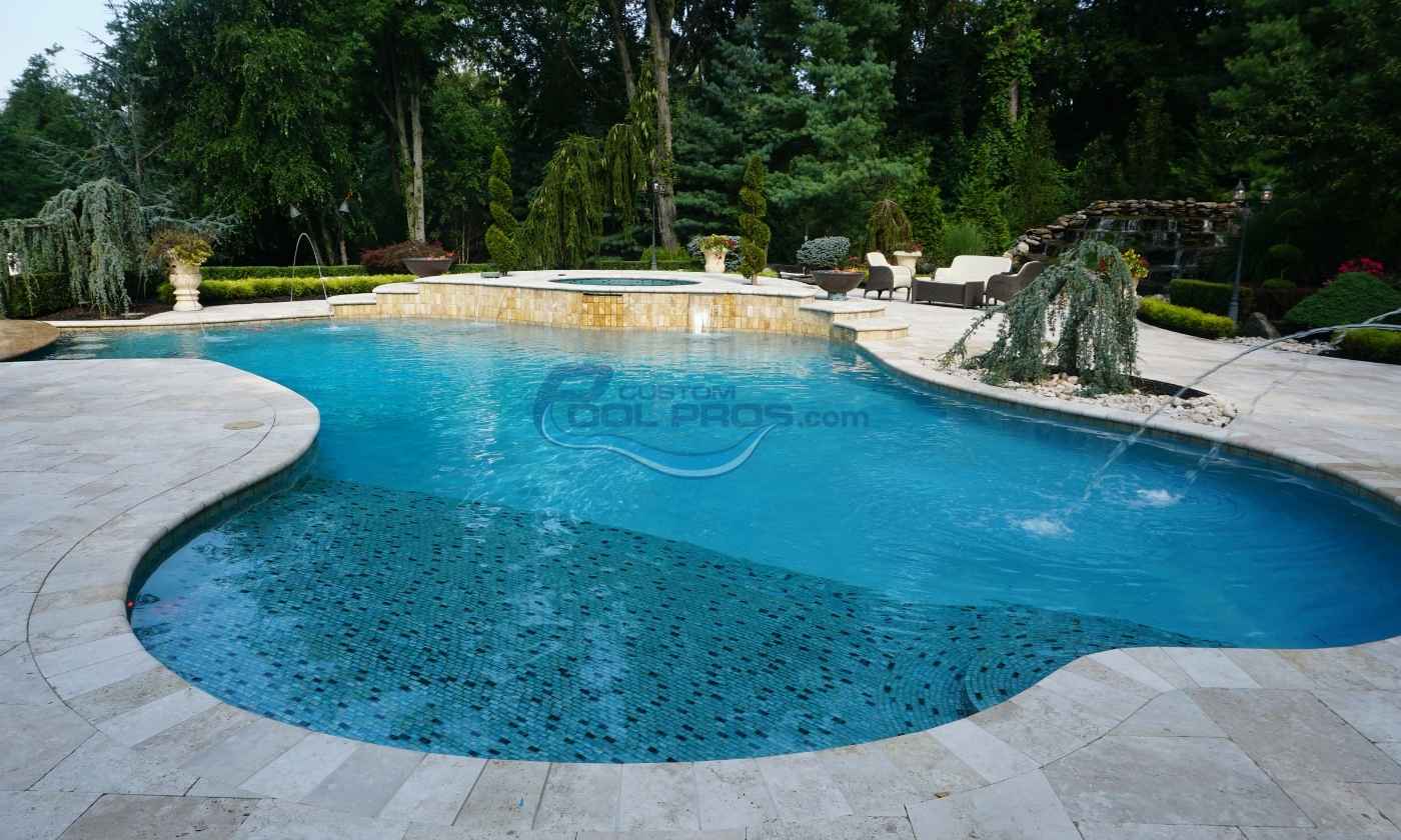 Stunning outdoor swimming pool with crystal-clear blue water, surrounded by lush greenery and elegant stone decking, perfect for relaxation and leisure.