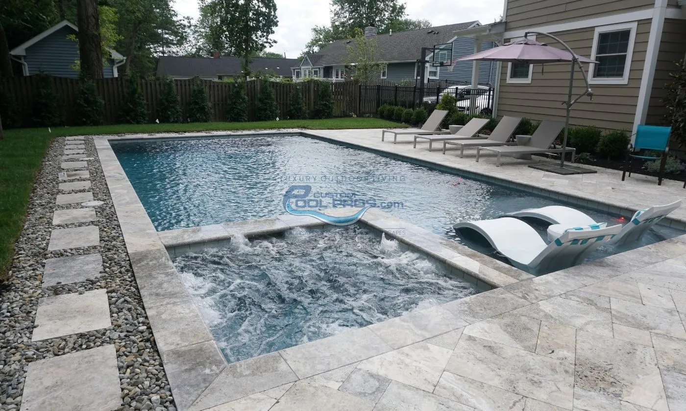 inground pool with spa and sun tanning ledge with chaise lounge chairs, inground pool