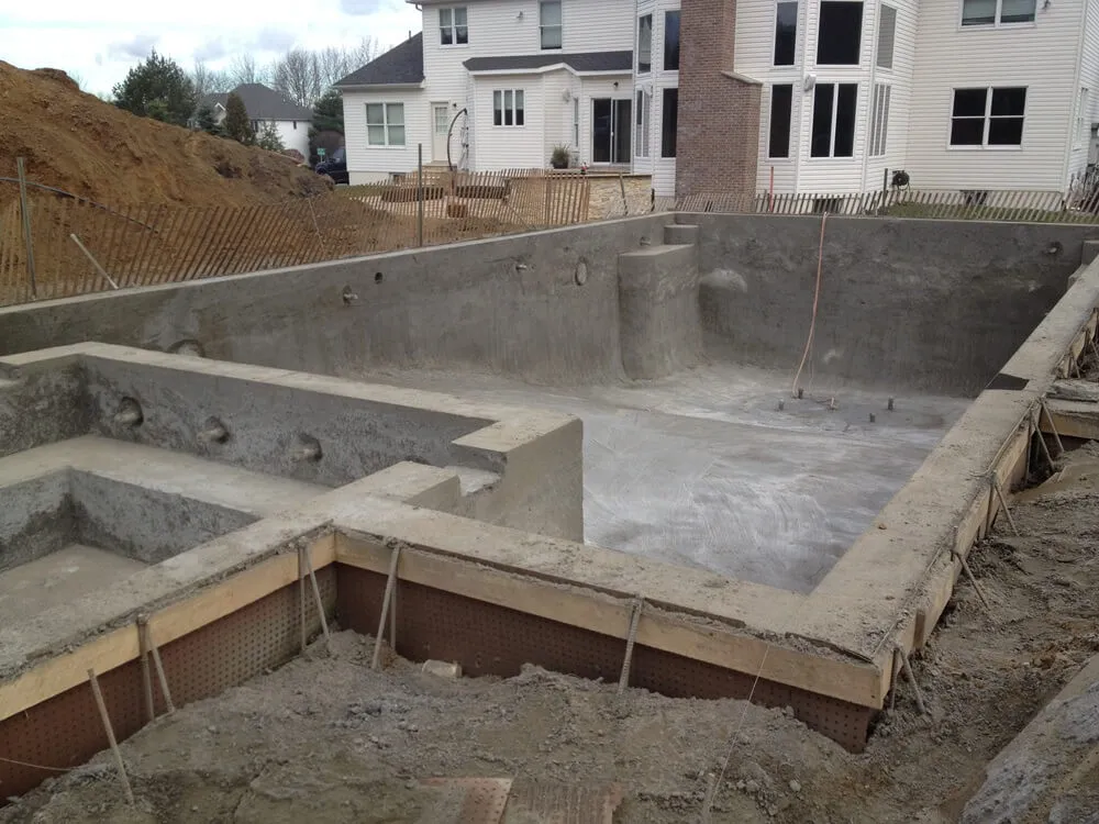 rectangular inground gunite concrete pool with spa under construction